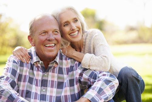 Elderly couple smiling for a picture.
